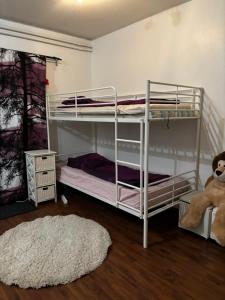 a bedroom with two bunk beds and a rug at Lapland Second Home in Rovaniemi
