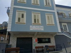 a building with a sign on the front of it at Parco Nazionale Cilento e Vallo di Diano Apartment in Casalbuono