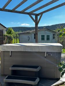 a outdoor kitchen with a pergola in a backyard at Chambre Raphaël les monts in Sainte-Feyre