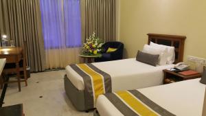 Postel nebo postele na pokoji v ubytování Regency Kanchipuram by GRT Hotels