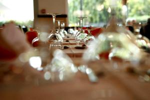 a long wooden table with wine glasses on it at Hotel Marebello in Rimini