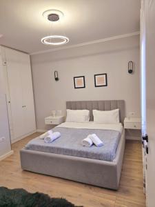 a bedroom with a bed with two towels on it at Siart Apartment in Tirana