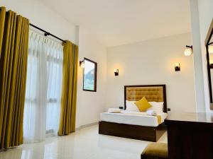 una camera da letto con un letto e una grande finestra di Heaven Breeze a Kandy