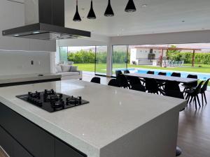 a kitchen with a stove top island in a room at Casa de Campo VIP San Andrés in San Andrés