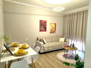 a living room with a couch and a table at Nea Apartment in Tirana