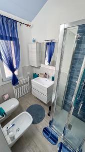 a bathroom with a shower and a toilet and a sink at Palazzo Nicole in Adria +63 photos