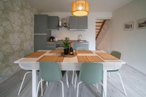 a kitchen with a wooden table and chairs at Tana LEONE in Marone
