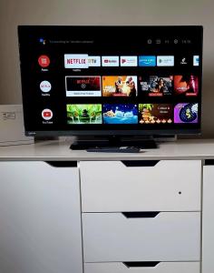 a television sitting on top of a white cabinet at casa penelope in Costa Del Silencio