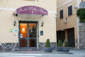a front door of a building with a sign on it at Hotel Villa Flora in Bogliasco