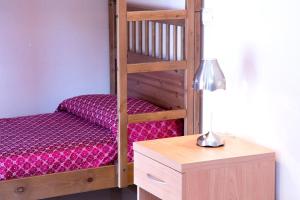 a wooden bunk bed with a desk and a lamp at Hotel Villa Flora in Bogliasco