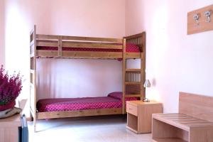 a bedroom with two bunk beds in a room at Hotel Villa Flora in Bogliasco