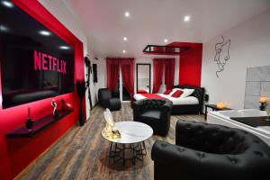 a hotel room with a bed and a living room at L'Arena - Love Room, Jacuzzi in La Seyne-sur-Mer