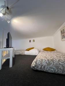 a bedroom with two beds and a television in it at Maison Trionfale a 2 passi dal Vaticano in Rome