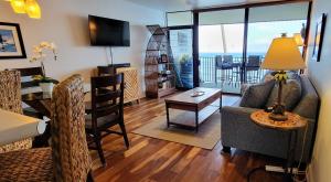 a living room with a couch and a table at Check In, Chill Out - Annies Surf Shack Awaits! in Kahana
