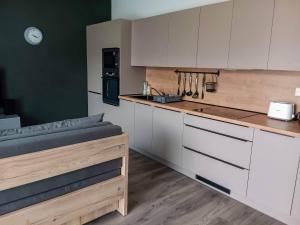 a kitchen with white cabinets and a counter top at Apartmán Lesanka in Oravská Lesná