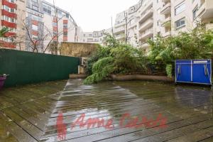 a rainy street with water on the ground and buildings at Appart 6 pers joinville Bois de Vincennes in Joinville-le-Pont