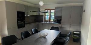 a kitchen with a table and some chairs and a table and chairsktop at Alpenchalets Zugspitze in Grainau