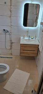 a bathroom with a sink and a toilet and a mirror at Woodhouse Maja in Virpazar +82 photos