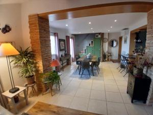 an open living room with a table and chairs at Hauts de st pierre belle terrasse Fayence in Fayence