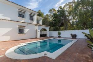 a swimming pool in the backyard of a house at Valdeazahares House in El Puerto de Santa María