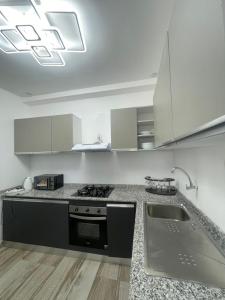 a kitchen with a stove and a sink in it at BBImmo APPART HOTEL in Dakar