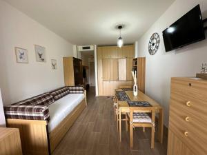 a bedroom with a bed and a desk and a table at Casa Del Tramonto-Golden House in Dosso