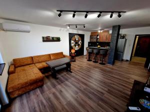 a living room with a couch and a table at Rebeka Luxury Apartment in Tryavna