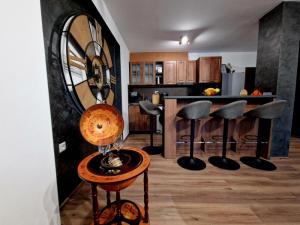 a living room with a table with a mirror at Rebeka Luxury Apartment in Tryavna