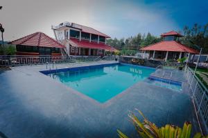 a large swimming pool in front of a house at Mountain Peak Resort in Hassan