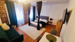 a living room with a bed and a couch at Vamesu Frontiers in Sibiu