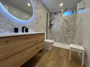 a bathroom with a sink and a toilet and a mirror at Apartamentos Villacarriedo in Villacarriedo +54 photos
