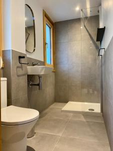 a bathroom with a toilet and a sink and a shower at 4 Bedroom, 4 Bathroom, Hot Tub, Chamonix Centre in Chamonix-Mont-Blanc +19 photos