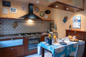 a kitchen with a table with a blue table cloth at Lago di Sole X 6 Point Break in Marone +38 photos
