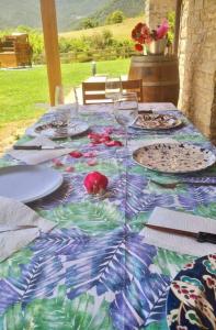 a table with a table cloth with plates and wine glasses at La Era de Lardiés in Lardiés +40 photos