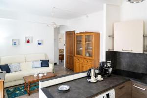 a kitchen and a living room with a couch at La casa di Ros in Perinaldo