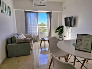 a living room with a table and a chair at El departamento de Mel in Villa Luzuriaga