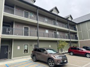 a apartment building with cars parked in front of it at N Walnut Street in Bloomington
