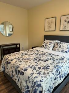 a bedroom with a bed with a blue and white comforter at N Walnut Street in Bloomington