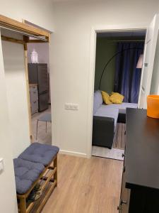 a small room with a bed and a small bedroom at Reiņu meža Apartaments in Liepāja