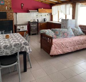 a kitchen with a bed and a table in a room at Moza in Trevelin
