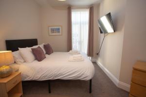 Ένα ή περισσότερα κρεβάτια σε δωμάτιο στο Norton Serviced Apartments