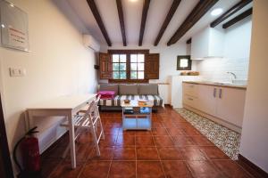 eine Küche mit einem Tisch und einer Spüle in einem Raum in der Unterkunft Apartamentos El Pozo1 in Villanueva de la Vera