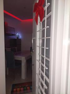 a door to a room with a table and a red bow at Gaia Pia Home in Bacoli +15 photos