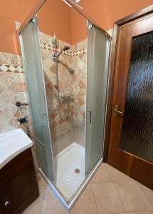 a shower with a glass door in a bathroom at Farax's House in Saint Vincent