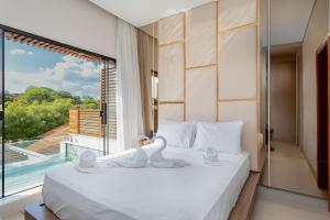 a bedroom with a large bed with a large window at Pousada Villas Bonito in Bonito +125 photos
