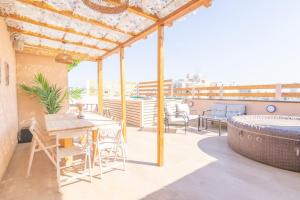 a patio with a hot tub and a table and chairs at Sinai Sunrise in Netanya