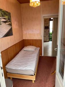 a small bedroom with a bed in a room at Maison calme proche Paris in Le Plessis-Robinson