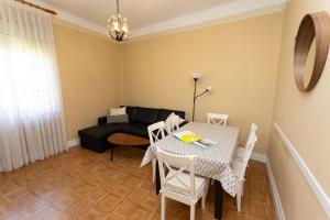 a living room with a table and a couch at Sea Breeze and beautiful views! in Muros de Nalón