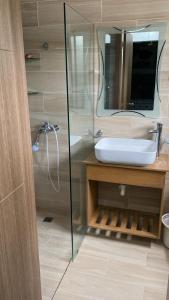 a bathroom with a sink and a mirror at Residencial Mediterraneo in Santiago de los Caballeros