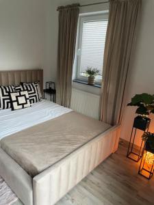 a bedroom with a large bed and a window at Villa Stella Strandnah in Gryfice